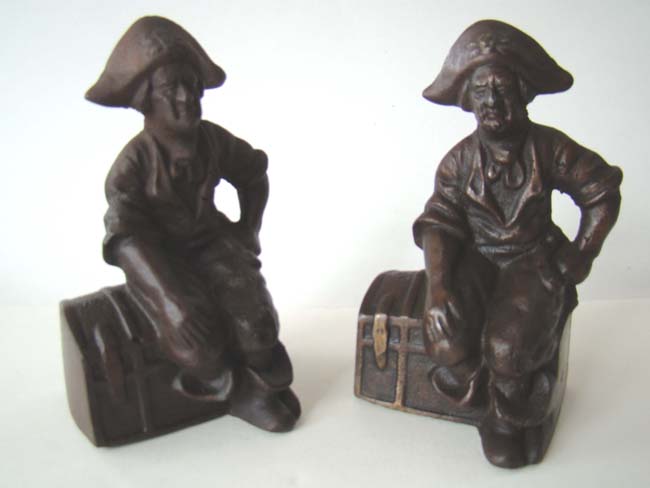 A charming pair of Antique Bookends circa 1900 depicting a Pirate sitting on a Treasure Chest